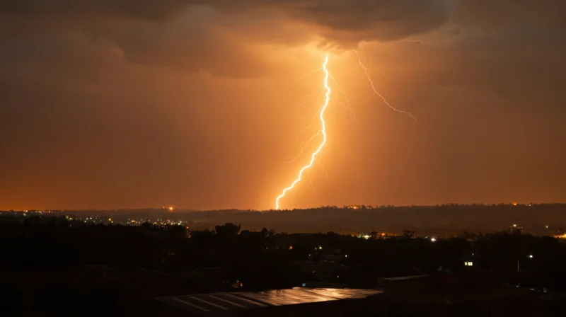 Jagged lightning bolt striking over a dark city skyline at night