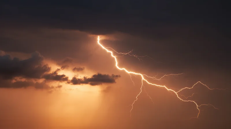 Lightning striking through dark storm clouds in a dramatic night sky