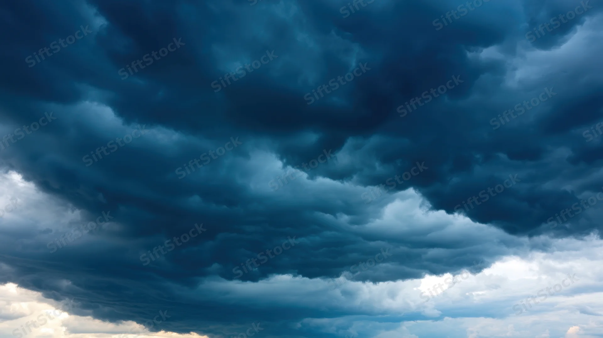 Dark storm clouds filling the sky with dramatic blue and white contrasts