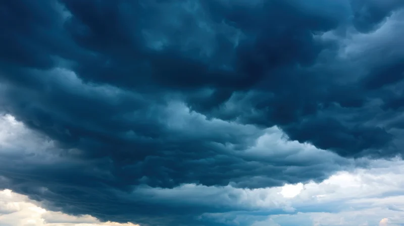 Dark storm clouds filling the sky with dramatic blue and white contrasts