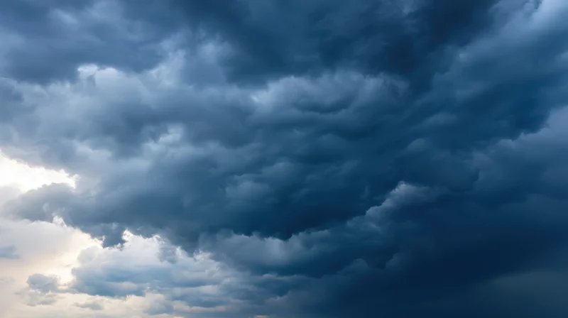 Dark storm clouds filling the sky with sunlight breaking through on the left