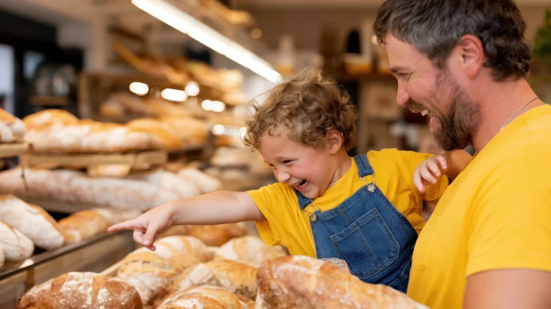Father and son smiling while pointing at bread in a bakery display