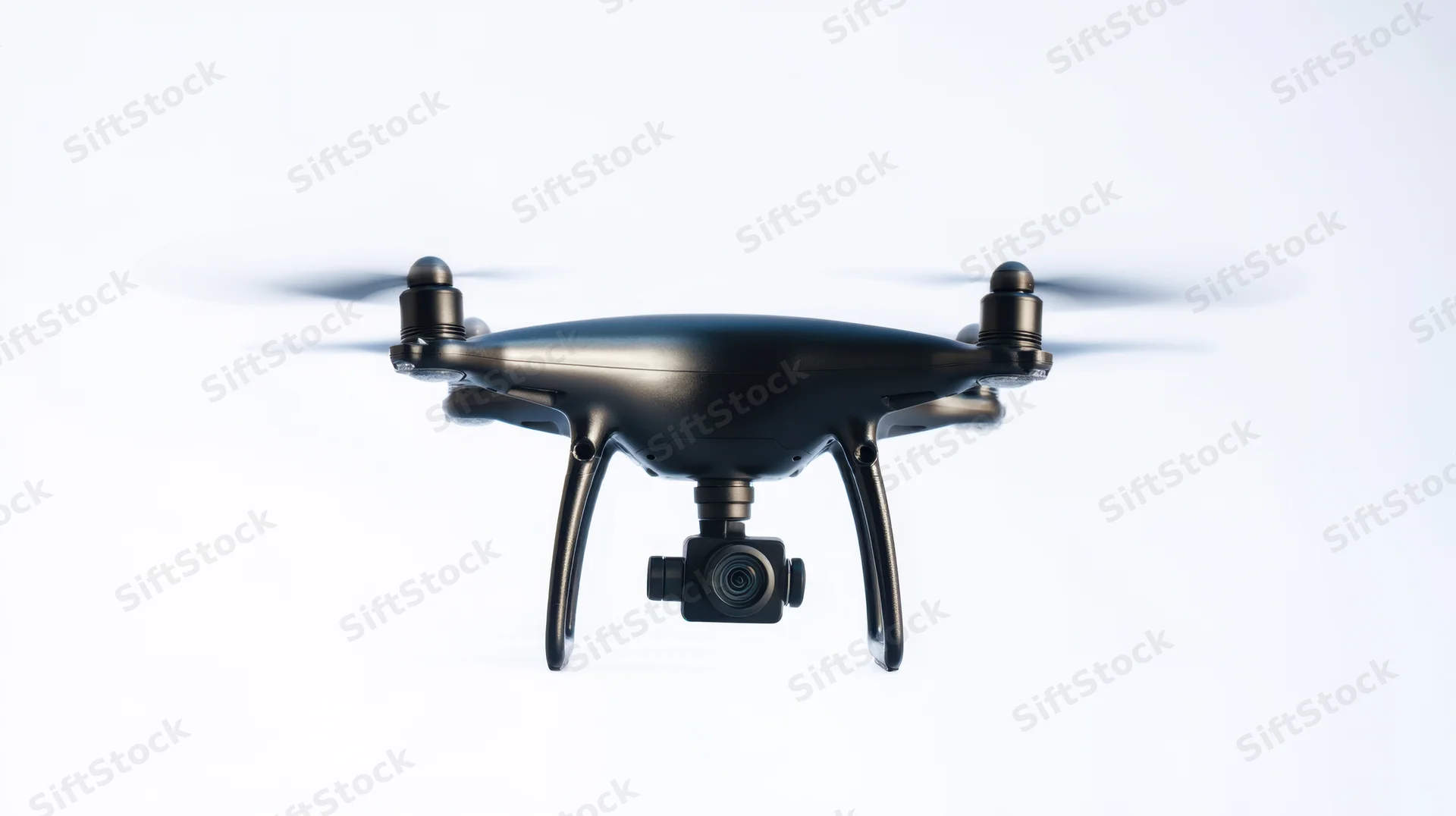Black quadcopter drone hovering with camera attached, isolated on white background