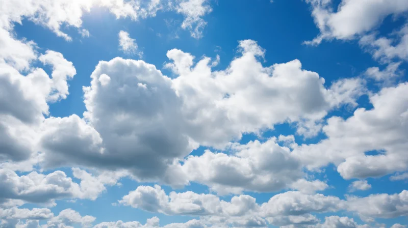 Bright blue sky filled with fluffy white clouds on a sunny day