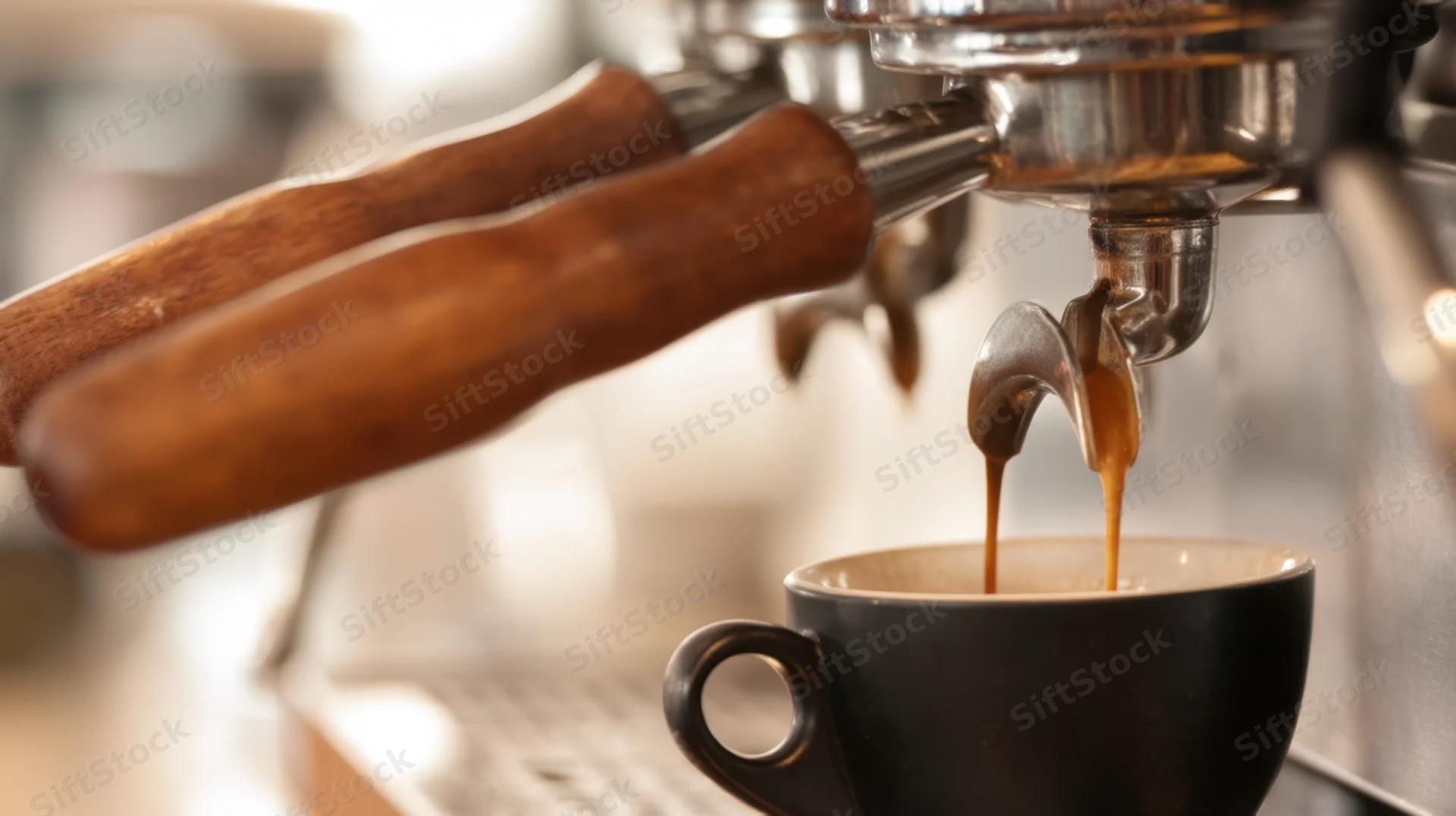 Espresso machine pouring coffee into a black cup in a cafe
