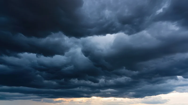 Dark storm clouds filling the sky with a hint of light at the horizon