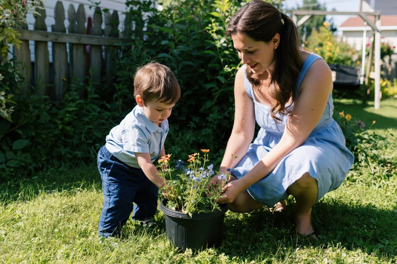 Woman and toddler tending potted flowers in a sunlit backyard garden